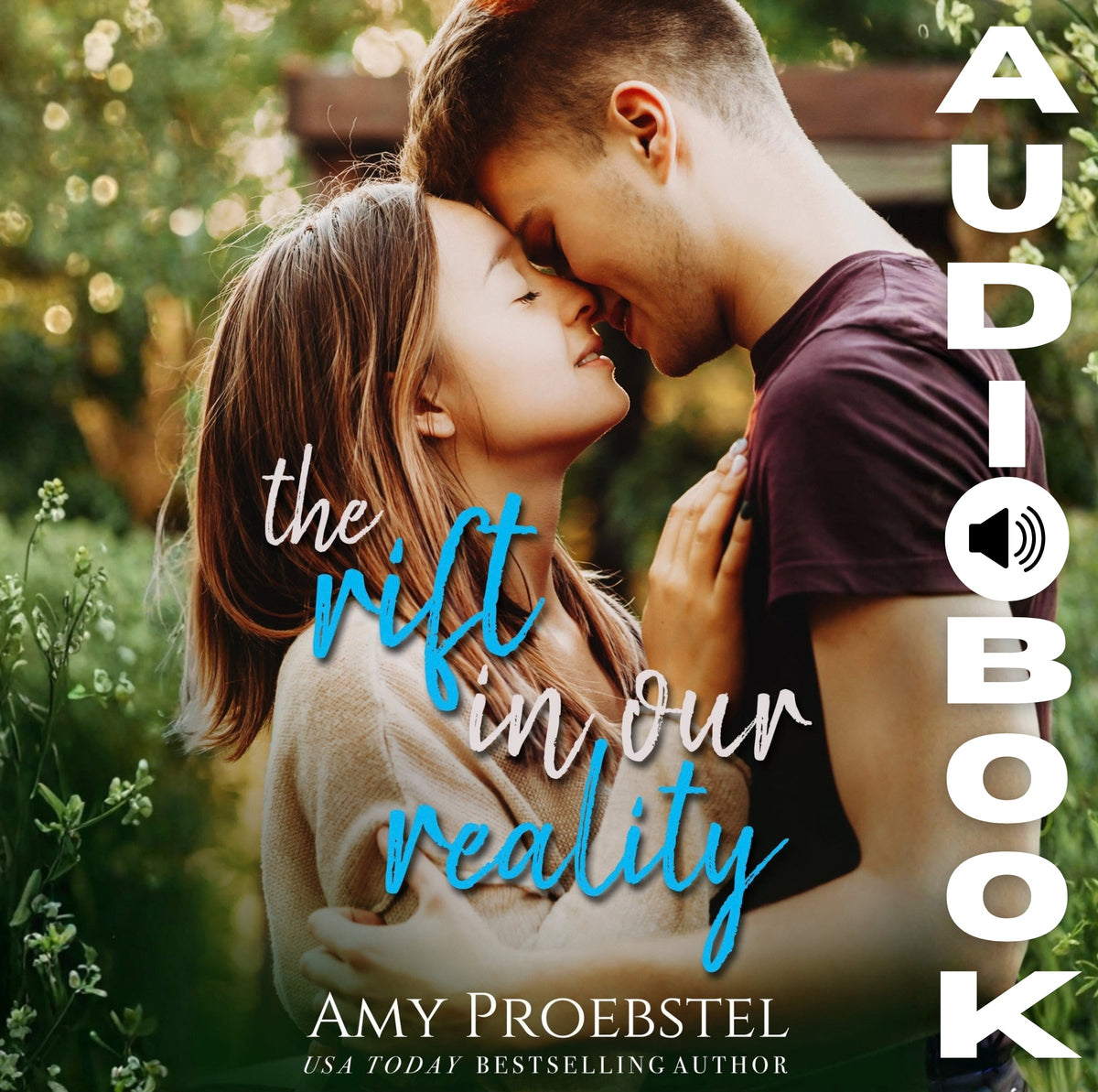 Audiobook cover for 'The Rift in Our Reality' by Amy Proebstel, featuring a close-up of a couple embracing in a sunlit outdoor setting, with the title in blue and white script and 'AUDIOBOOK' printed vertically on the right.