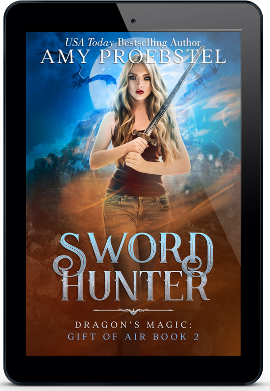 A tablet device displaying the book cover for 'Sword Hunter' by Amy Proebstel. The cover art features a fantasy scene with a woman holding a sword, blue and orange lighting, and the title in large metallic-style lettering.