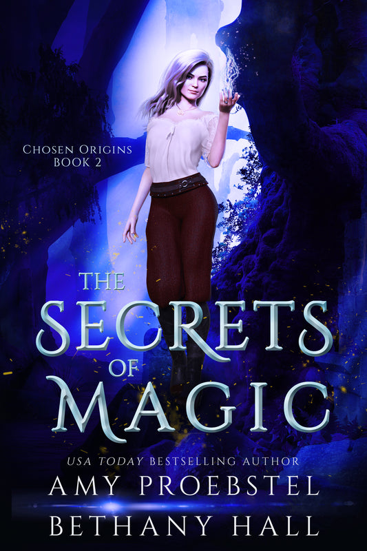 Book cover for 'The Secrets of Magic' by Amy Proebstel and Bethany Hall, featuring a woman in a white blouse and brown skirt standing in a glowing blue cave, with large title text across the lower half.