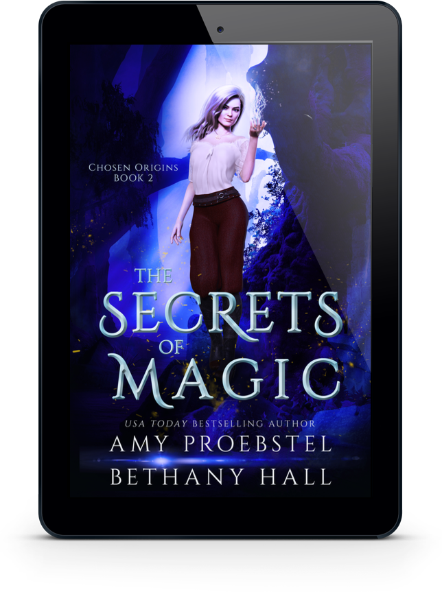 A black tablet device displaying the book cover for 'The Secrets of Magic' by Amy Proebstel and Bethany Hall, set against a plain white background.