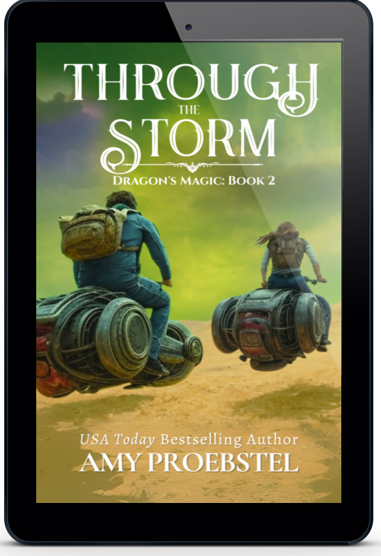 A black tablet device displaying the book cover for 'Through the Storm: Dragon's Magic: Book 2' by Amy Proebstel, shown on a clean white background.